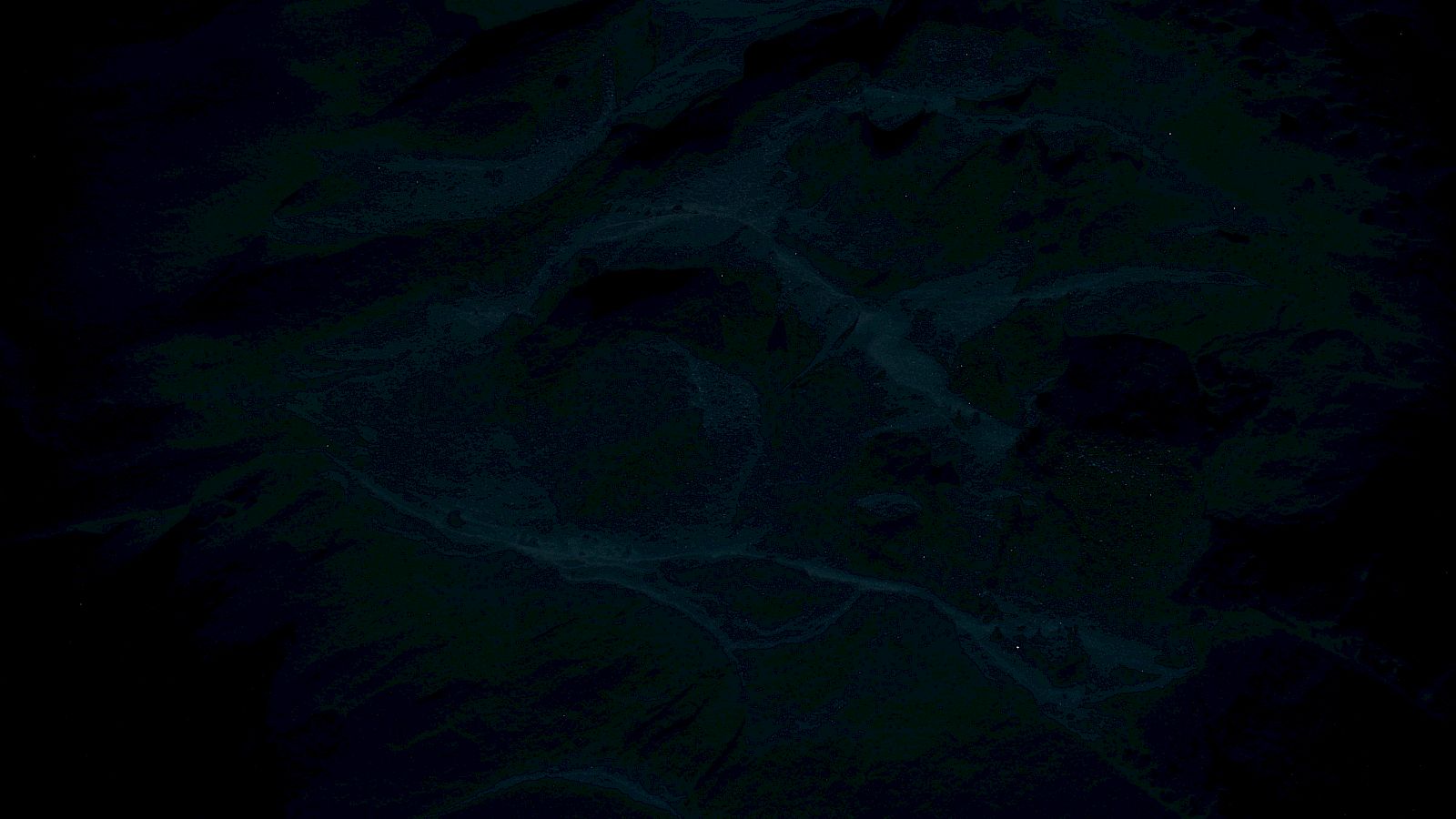 The image is too dark to discern any specific objects or details clearly, making it difficult to describe what's present in the scene.